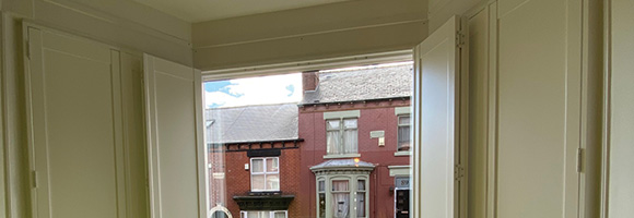 solid shutters on a window looking out the the house opposite